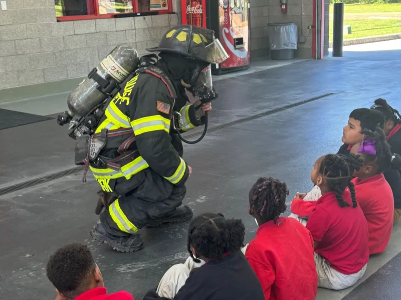 station 13 teaching children in engine bay